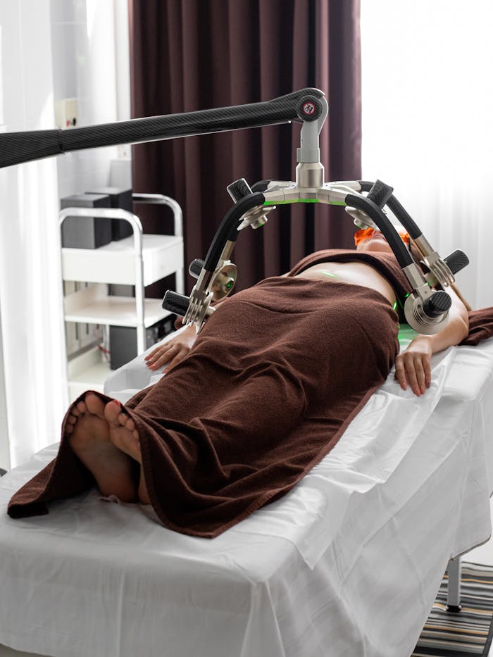 who-we-are Female patient undergoing a contemporary laser treatment for weight loss in a medical clinic.
